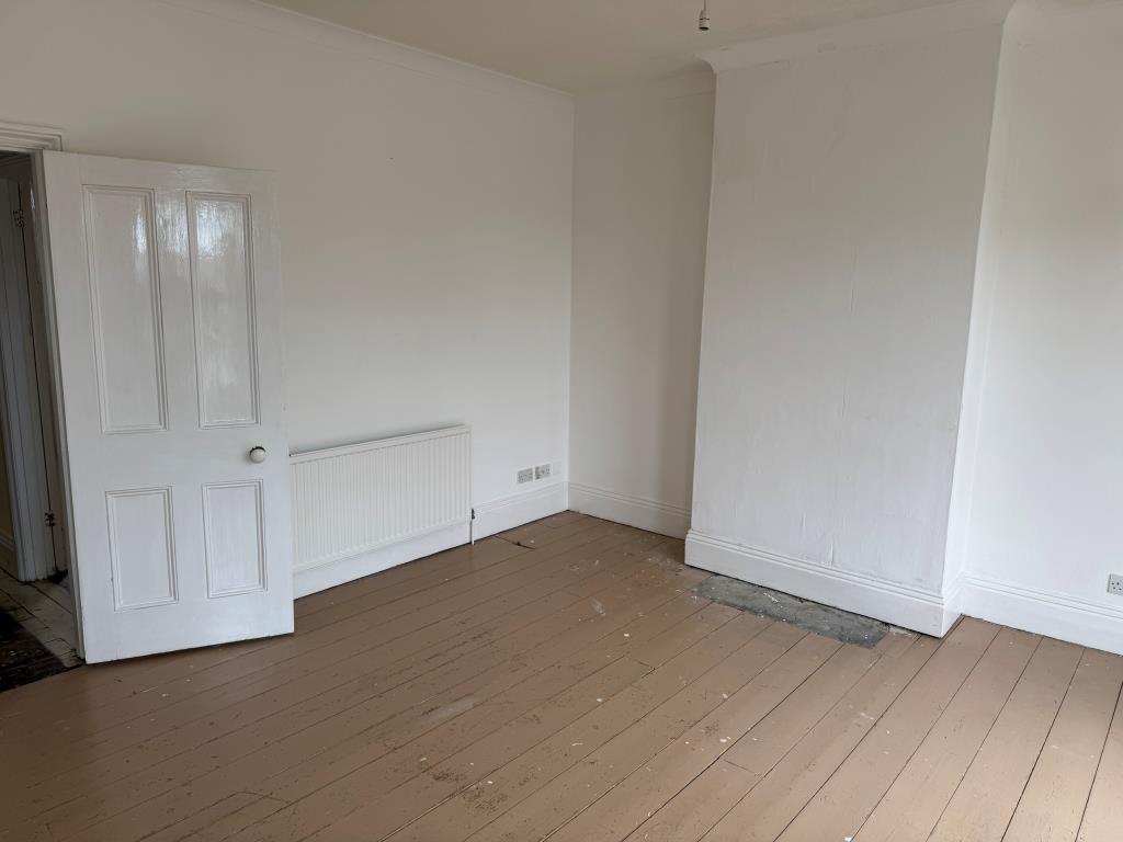 Lot: 80 - FREEHOLD TOWN CENTRE HOUSE COMMERCIAL INVESTMENT AND CAR PARK - Bedroom with wooden floor and white walls